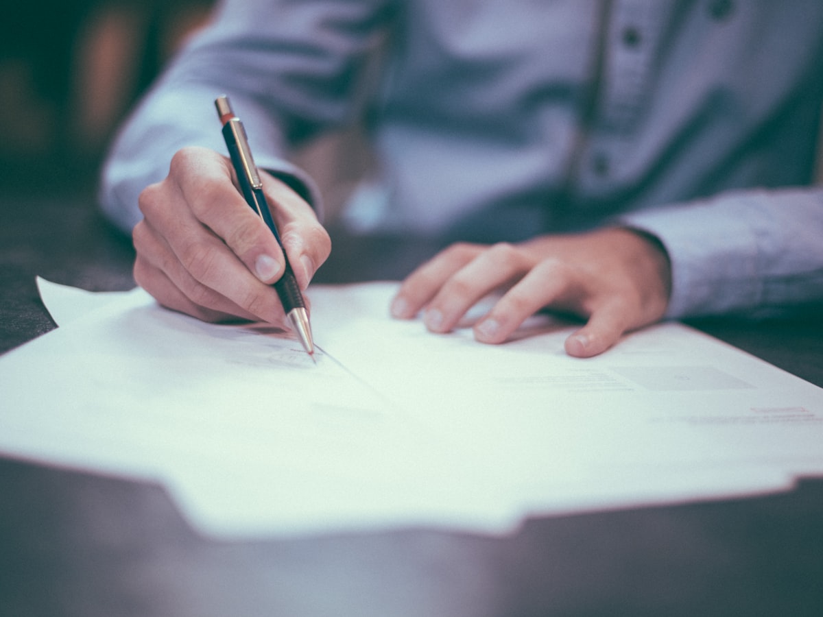 Reviewing contract terms and paperwork on a desk
